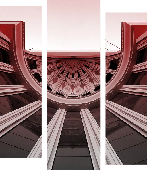 Barings Law Home Main Image - Ground view of a building as though you are looking up. Colour has gradient dark red to grey from top to bottom and is split into three sections.