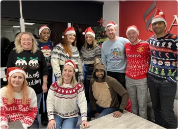 Careers Barings Law image - Barings Law team photo. Everyone is wearing Christmas Jumpers for Christmas Jumper Day 2022.