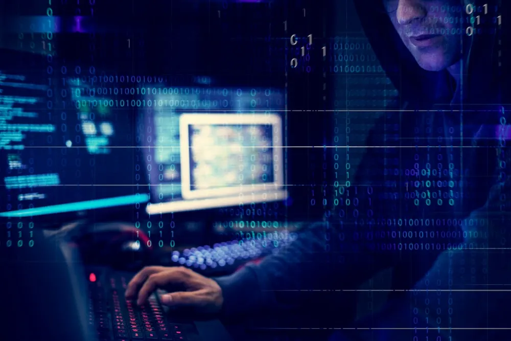Hacker at computer screen. Capita Data Breach featured image.