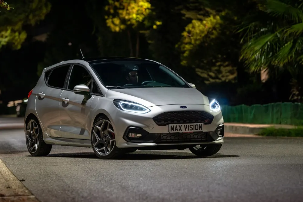 Silver Ford Fiesta at night.