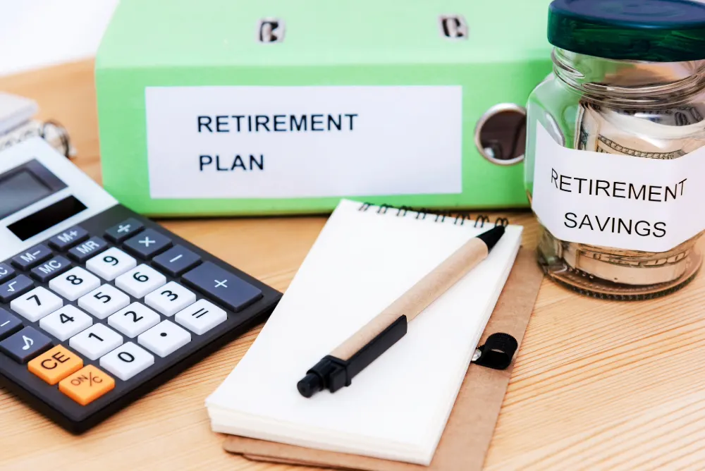Mis-sold Pensions - The tell-tale signs featured image. Image shows a notebook, a calculator, a jar with retirement savings on and a folder with retirement plan on.