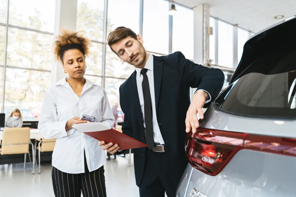 Personal Contract Purchase featured image. Car dealer showing a woman a car.